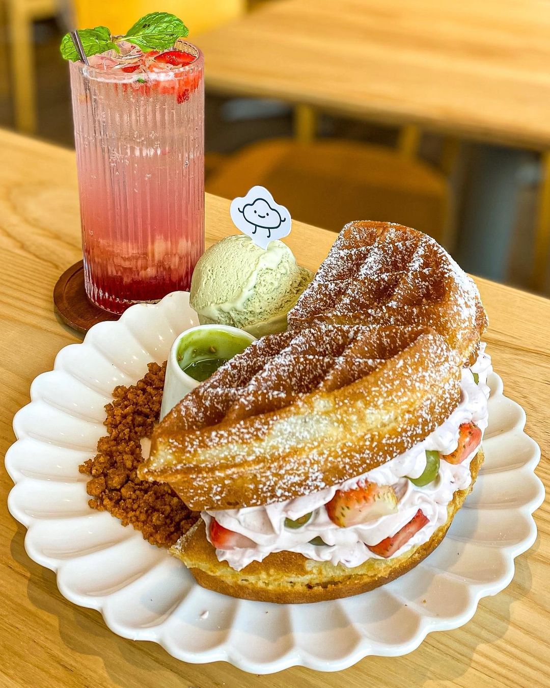 Selection of KL desserts including egg tarts, cendol, coconut ice cream and kuih on a table