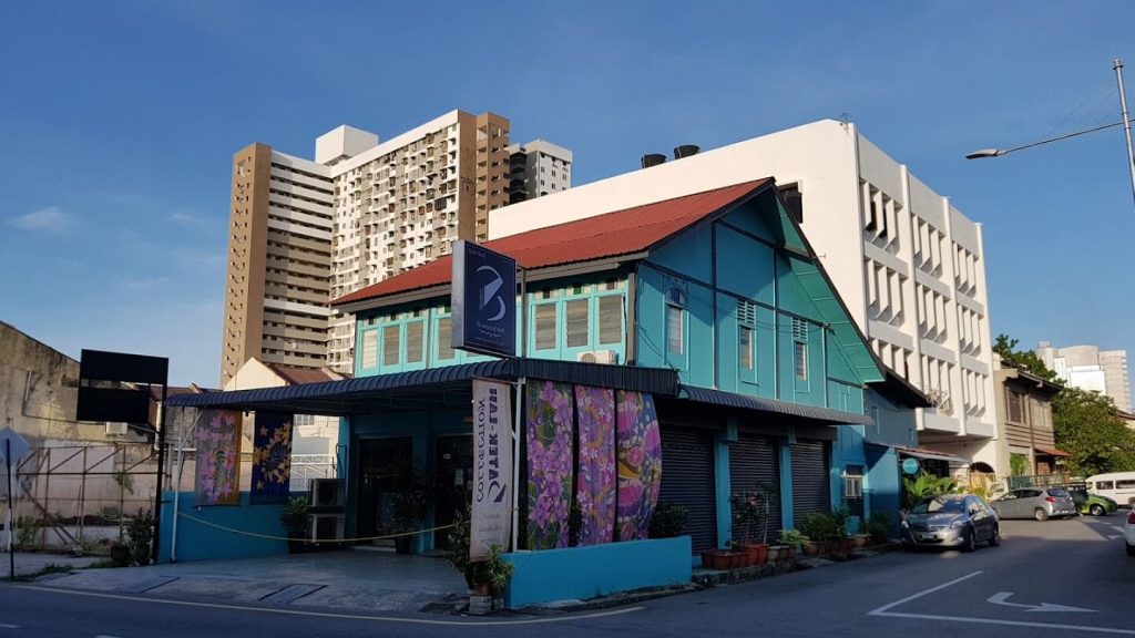 Handmade postcards, batik fabric and craft souvenirs displayed at a George Town shop