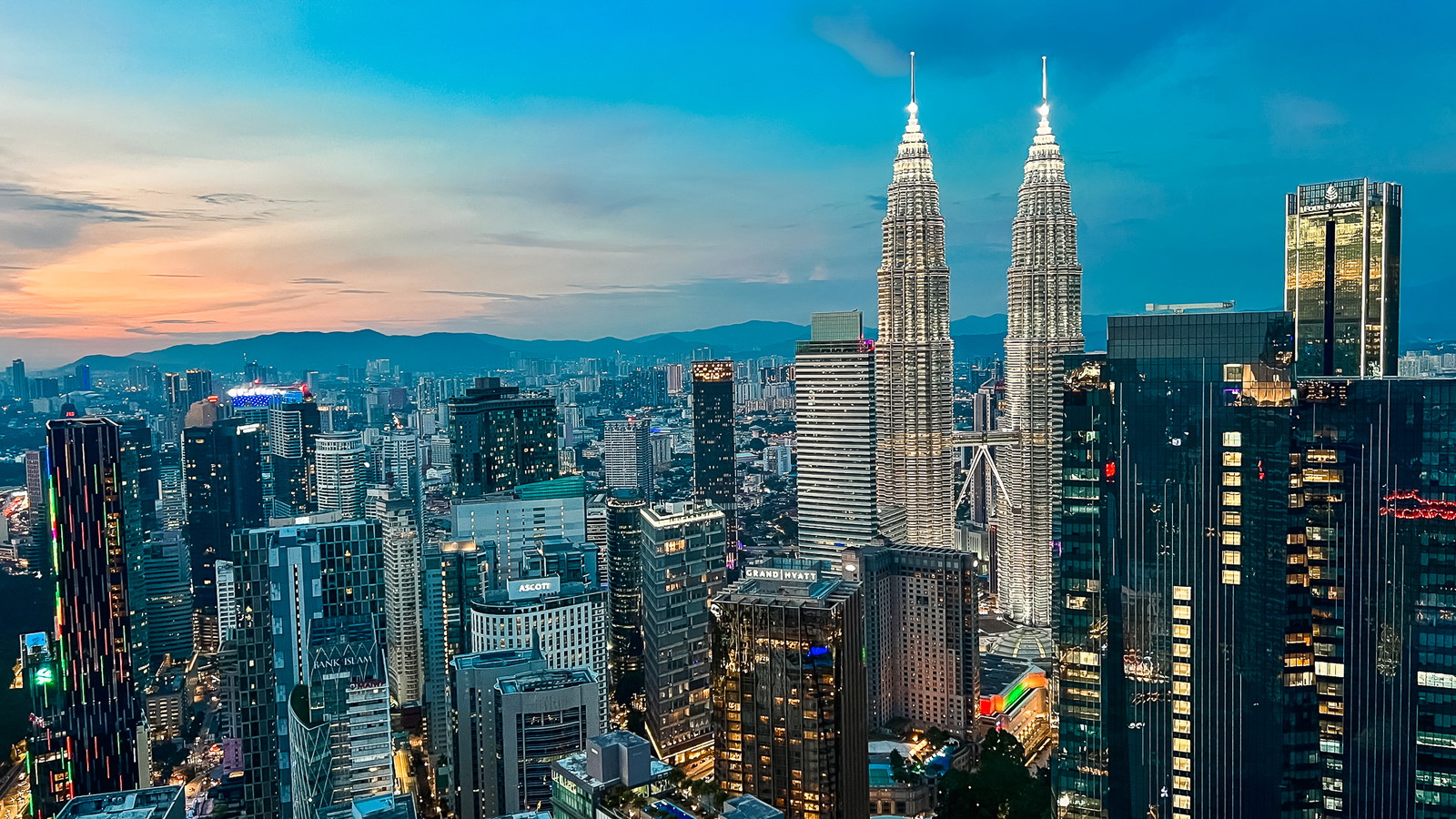 Kuala Lumpur skyline at night with the Petronas Twin Towers and KL Tower illuminated