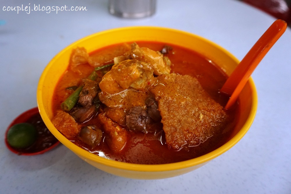 Tight alley of Madras Lane hawker stalls with vendors serving yong tau foo and laksa