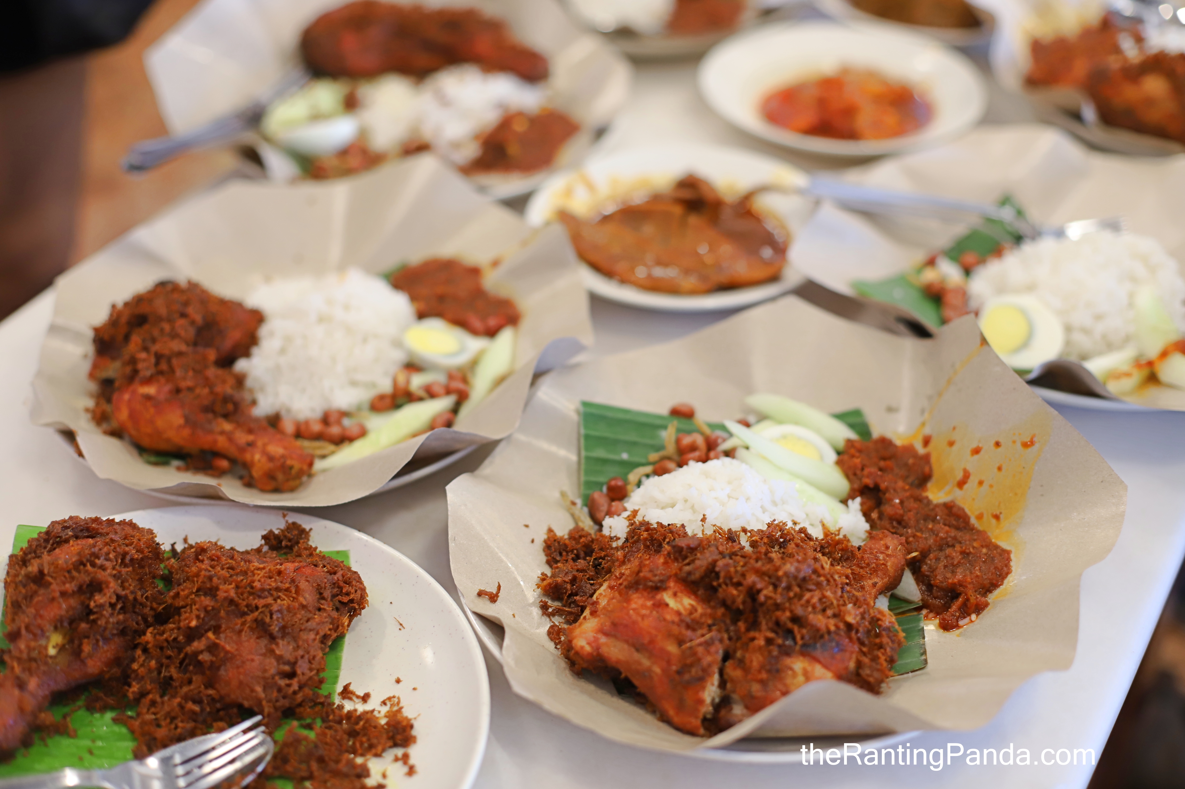 Village Park nasi lemak with a large piece of golden crispy fried chicken, sambal, rice and condiments