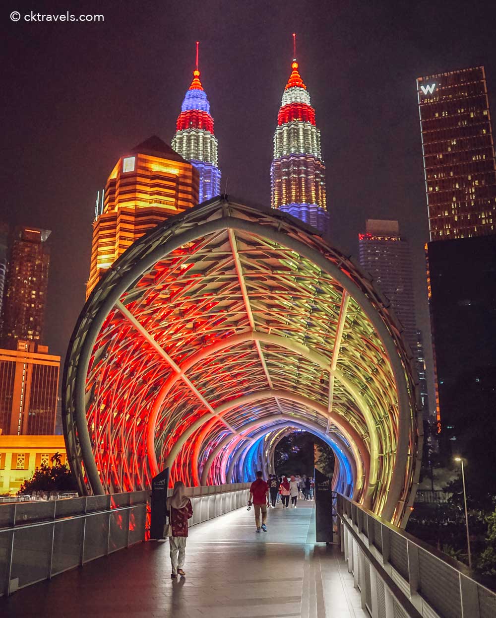 Colour-changing LED arches of the Saloma Bridge at night with Kuala Lumpur skyline