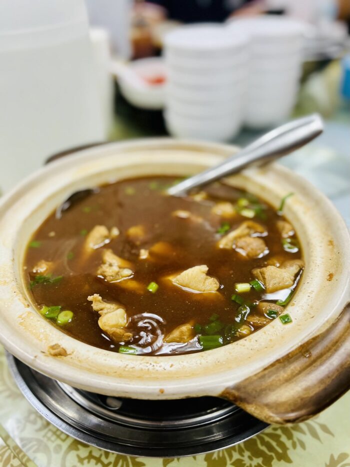 Clay pot of herbal bak kut teh with pork ribs and side dishes at Sun Fong